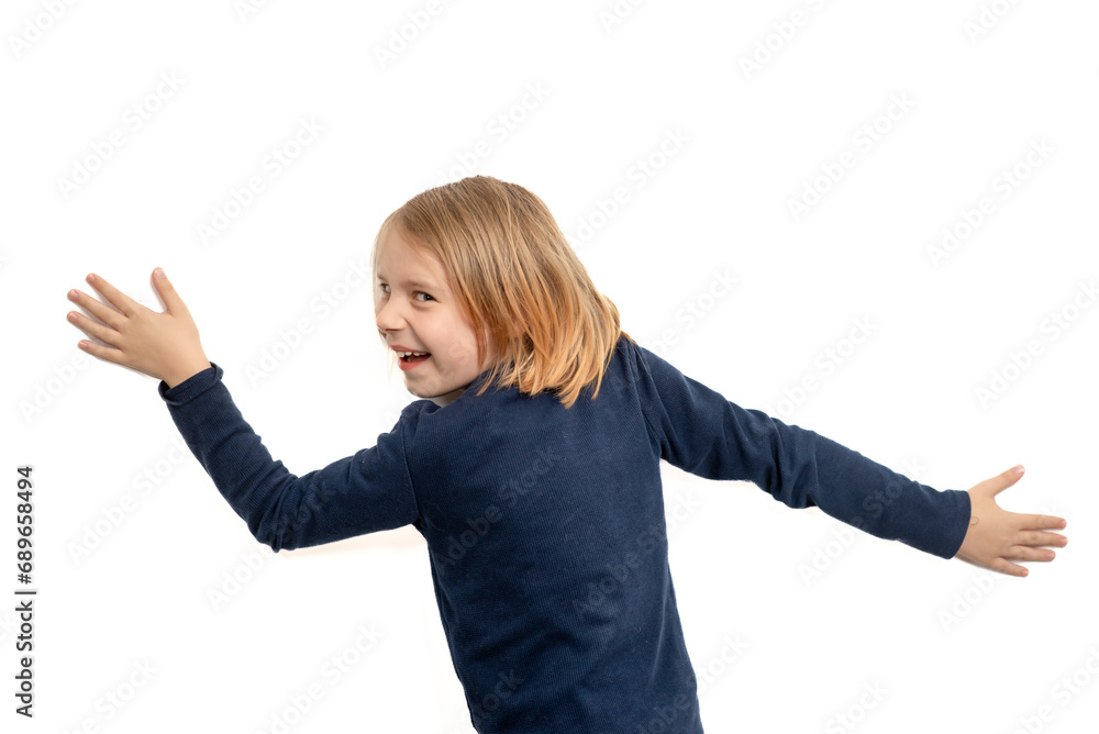 young boy with long hair just with his hands against the wall on a white background back view