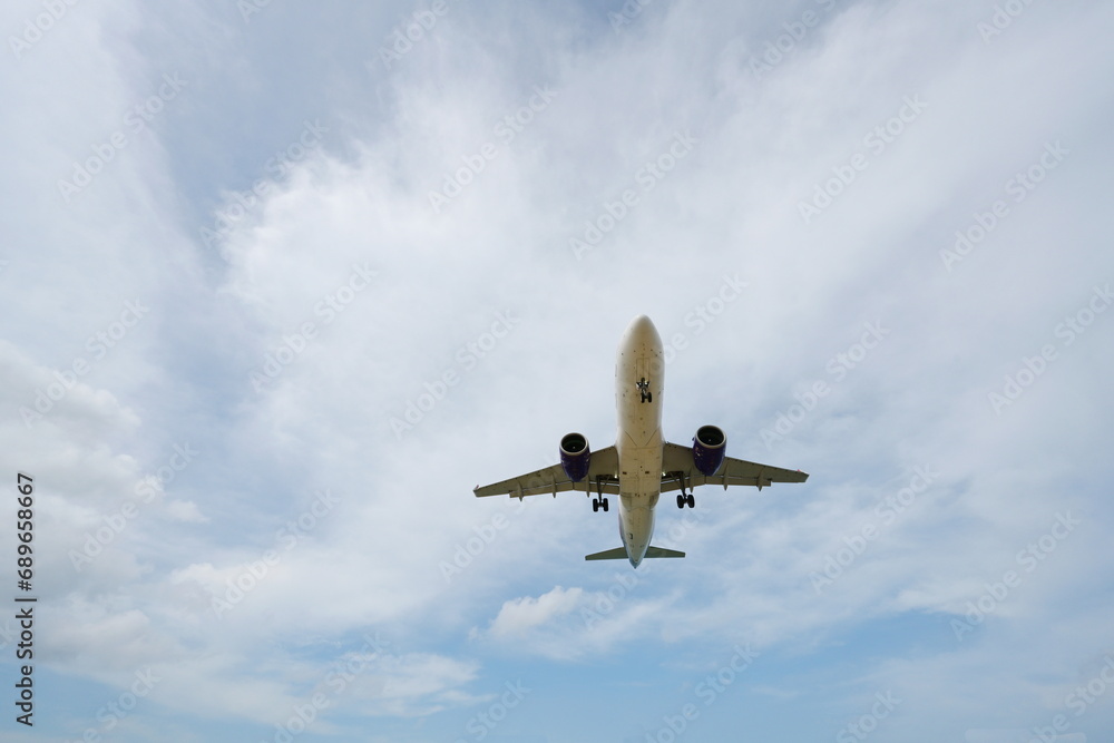 Passenger airplane flying in the sky clouds in the background. The white plane is about to land at the airport. The concept of holiday travel by airplane
Passenger airplane flying in the sky clouds in the background. The white plane is about to land at the airport. The concept of holiday travel by airplane
