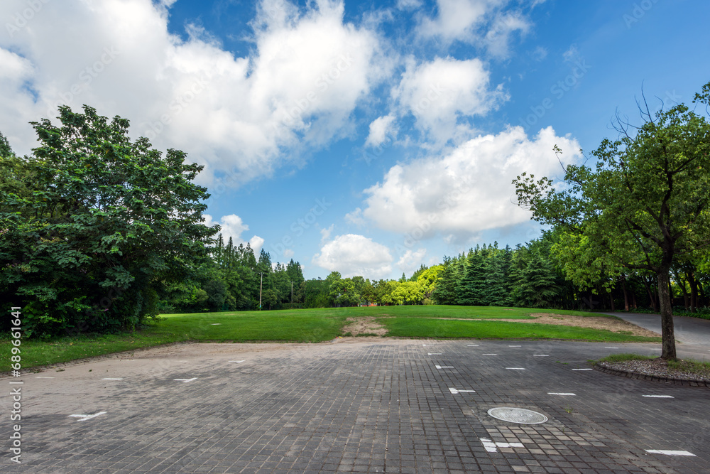 Blue sky, white clouds, grass, and trees in the city park Blue sky, white clouds, grass, and trees in the city park