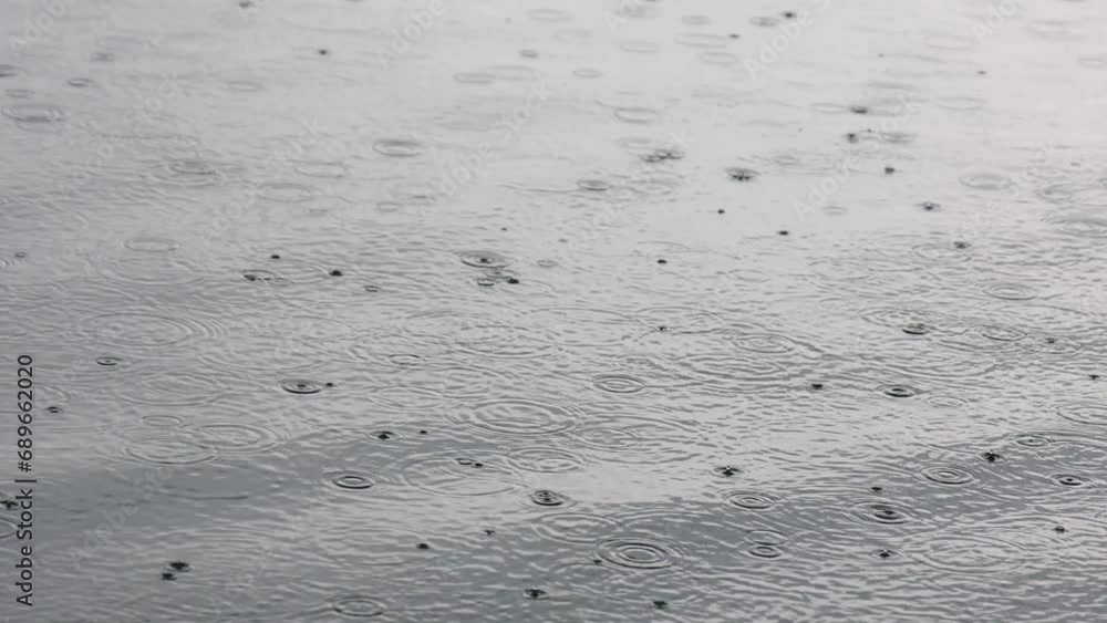 Rain on water. Raindrops on lake. Drops Splashing On Water Surface. Rain on water. Raindrops on lake. Drops Splashing On Water Surface.
