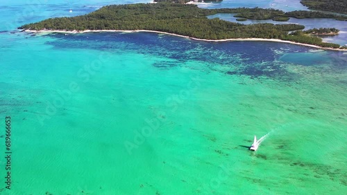 Panoramic aerial view of Ilot Mangenie, a private island and part of the luxury resort ShangriLa Le Touessrok with sailing boat, Flacq, Mauritius. photo