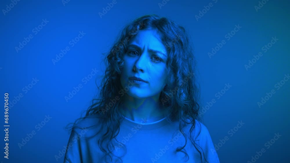 Portrait of Young Woman Looking at Camera with Thinking Face Close Up. Confused 20s Lady at Neon Shot Considering Thoughts of Work Plans or Pondering on Life Choices. Girl Model Doubting in Answers Portrait of Young Woman Looking at Camera with Thinking Face Close Up. Confused 20s Lady at Neon Shot Considering Thoughts of Work Plans or Pondering on Life Choices. Girl Model Doubting in Answers