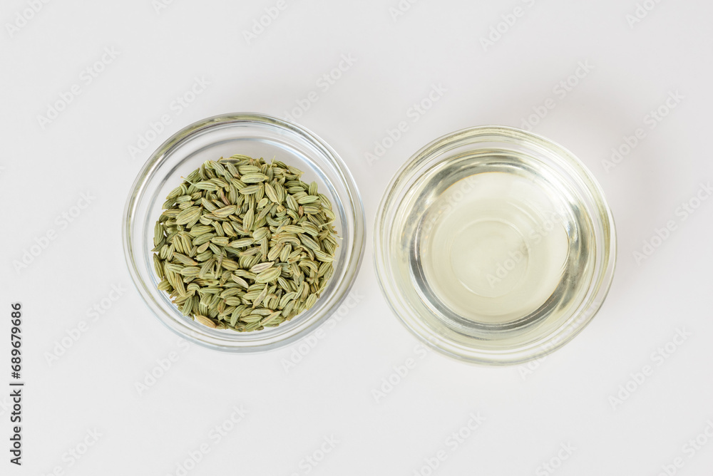 Fennel organic oil and fennel seeds in glass bowls isolated top view Fennel organic oil and fennel seeds in glass bowls isolated top view