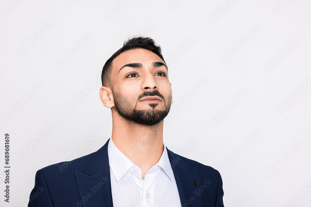 Delighted smart young handsome turkish man in smart ellegant suit standing over grey background in studio isolated. Delighted smart young handsome turkish man in smart ellegant suit standing over grey background in studio isolated.