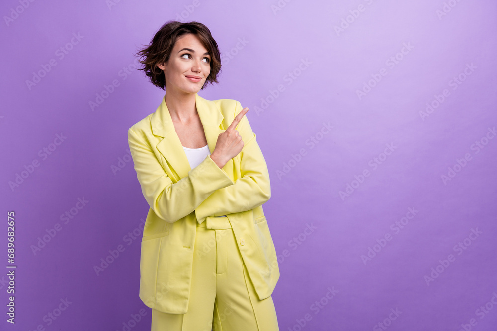 Photo of young charming girl promoting her new product on market current position direct finger mockup isolated on violet color background Photo of young charming girl promoting her new product on market current position direct finger mockup isolated on violet color background