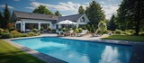 Backyard of an elegant house with swimming pool, blue sky in the background