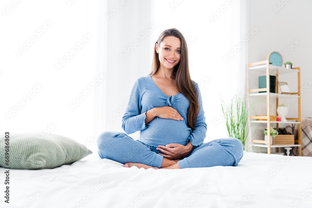 Photo of adorable pretty tender mom sitting in bed enjoying pregnancy home weekend morning white room interior indoors Photo of adorable pretty tender mom sitting in bed enjoying pregnancy home weekend morning white room interior indoors