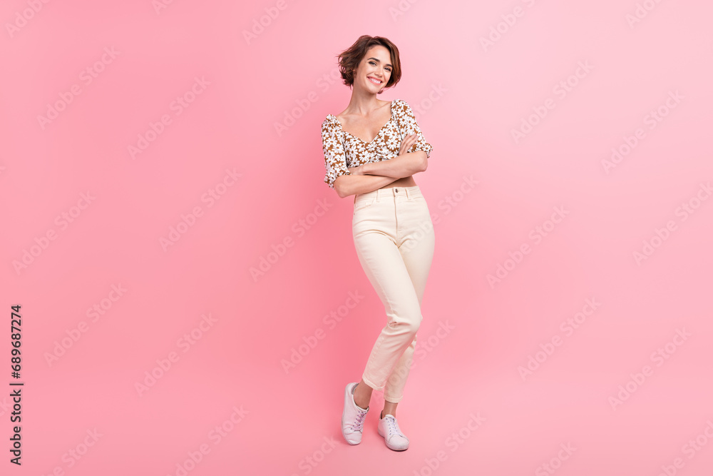 Full length photo of adorable satisfied young person crossed arms posing empty space isolated on pink color background Full length photo of adorable satisfied young person crossed arms posing empty space isolated on pink color background