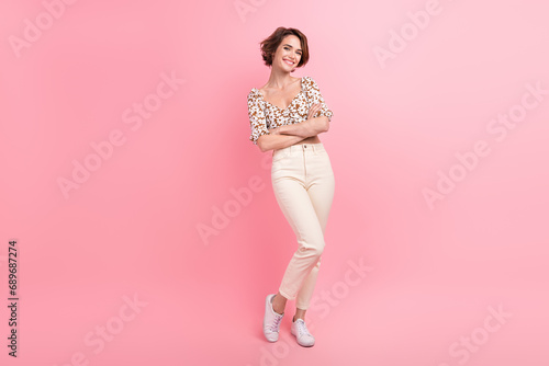 Full length photo of adorable satisfied young person crossed arms posing empty space isolated on pink color background