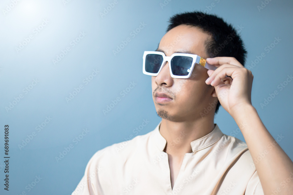 portrait Asian man standing with hand holding glasses, have a mustache portrait Asian man standing with hand holding glasses, have a mustache