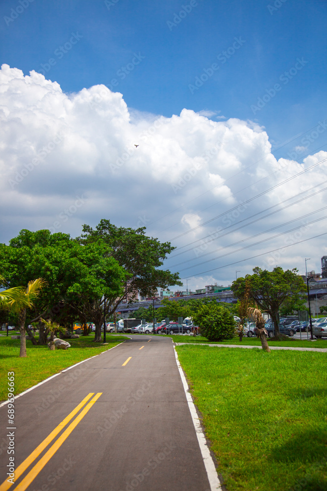 Fototapeta premium Blue sky and white clouds, river park, bicycle lane, bicycle, exercise