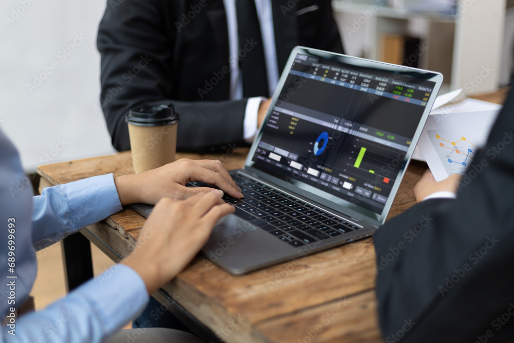 Meeting of business consultants analyzing financial charts and market growth charts to plan investment projects. Meeting of business consultants analyzing financial charts and market growth charts to plan investment projects.