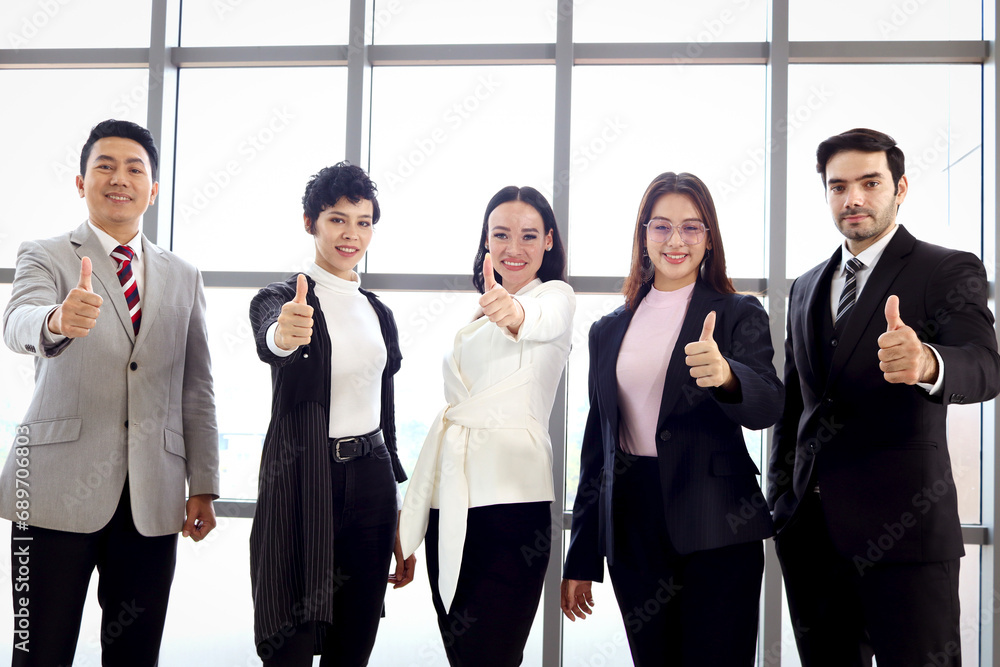 Portrait of five businesspeople, group of businessmen and businesswomen confident standing and give thumbs up to camera, business team at modern office. Team collaboration and power of teamwork. Portrait of five businesspeople, group of businessmen and businesswomen confident standing and give thumbs up to camera, business team at modern office. Team collaboration and power of teamwork.