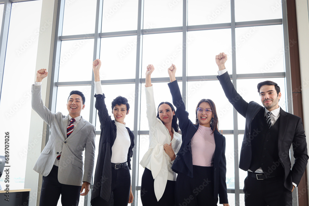 Portrait of five cheerful happy businesspeople, group of businessmen and businesswomen confident raising hands up to celebrate success, business team collaboration power of teamwork. Portrait of five cheerful happy businesspeople, group of businessmen and businesswomen confident raising hands up to celebrate success, business team collaboration power of teamwork.