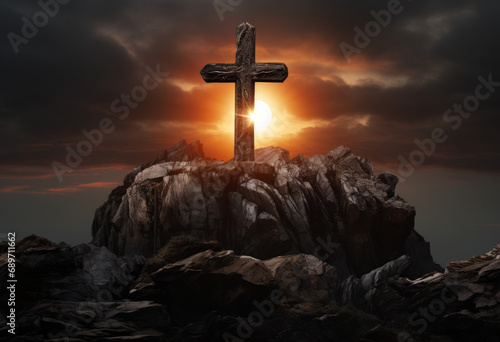 A cross on a rocky mountain summit at sunset. Easter theme or religious theme. Glow.