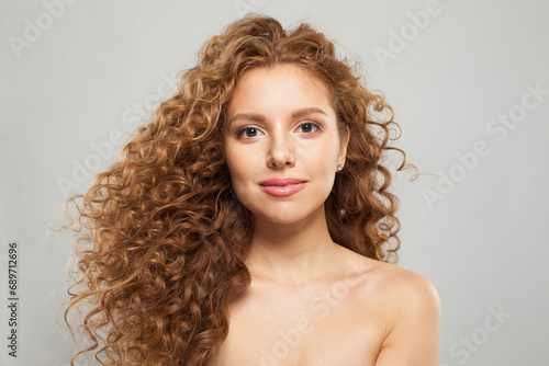 Perfect woman fashion model with long wavy hairstyle, natural makeup and clear skin. Haircare, facial treatment and skincare concept