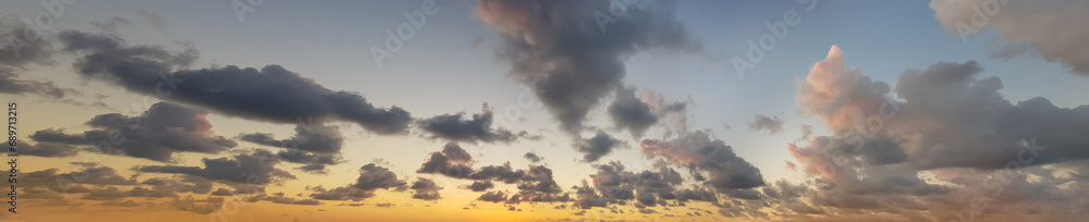 Sky panorama. Sunset sky with golden sun and colorful bright summer cloud