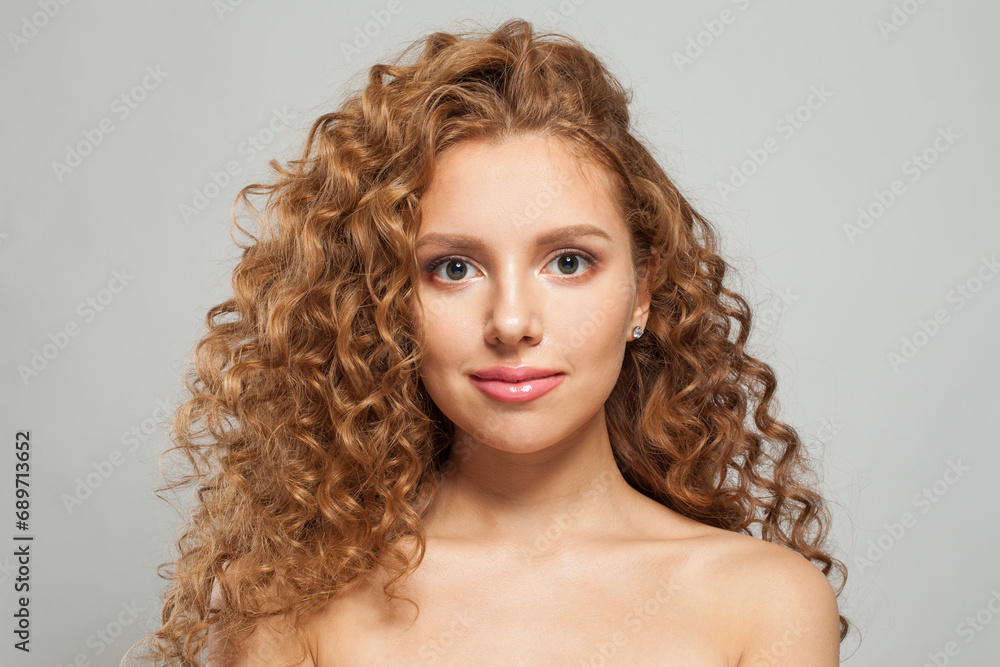 Nice redhead woman fashion model with shiny curly brown hair and natural healthy fresh skin on white background. Cosmetology, haircare and beauty treatment concept Nice redhead woman fashion model with shiny curly brown hair and natural healthy fresh skin on white background. Cosmetology, haircare and beauty treatment concept