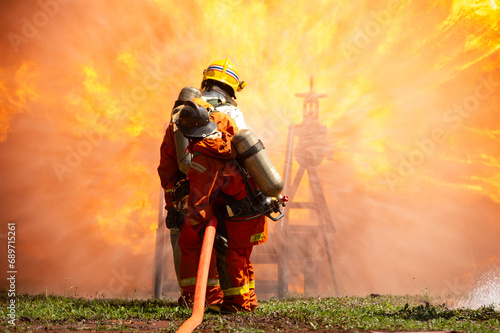firefighter train fireman team extinguish spraying fire gas explosion. Fire fighter learning stop fire burn under emergency case gas explosion. rescue service of Emergency gas explosion extinguish. © BESTIMAGE