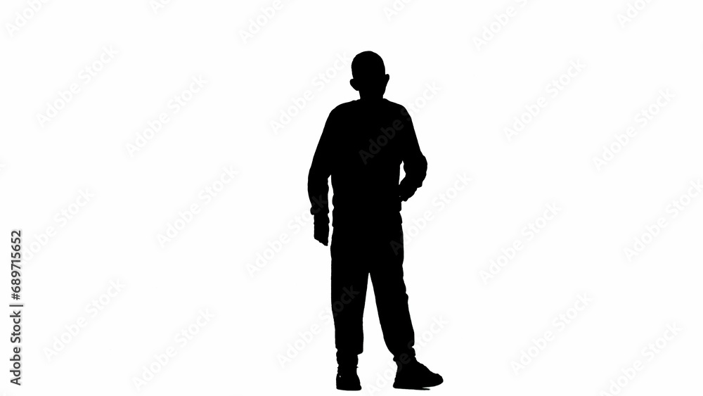 Portrait of kid boy isolated on white background with alpha channel. Silhouette of schoolboy standing posing at the camera with hand on waist.