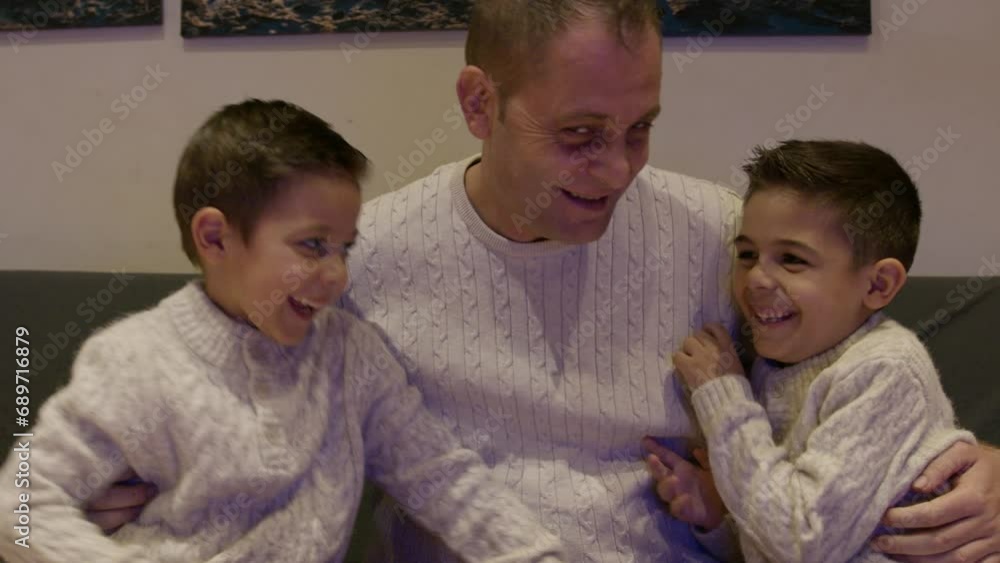 Father and sons cudldling on the couch. Quality family time. High quality 4k footage Father and sons cudldling on the couch. Quality family time. High quality 4k footage