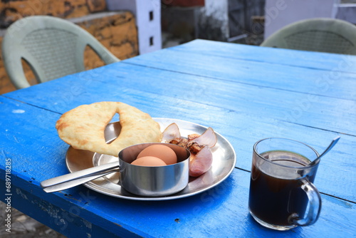 Gurung bread and eggs with the nepali black tea, a traditional Nepali breakfast in the lodge inside the poonhill trekking circle photo