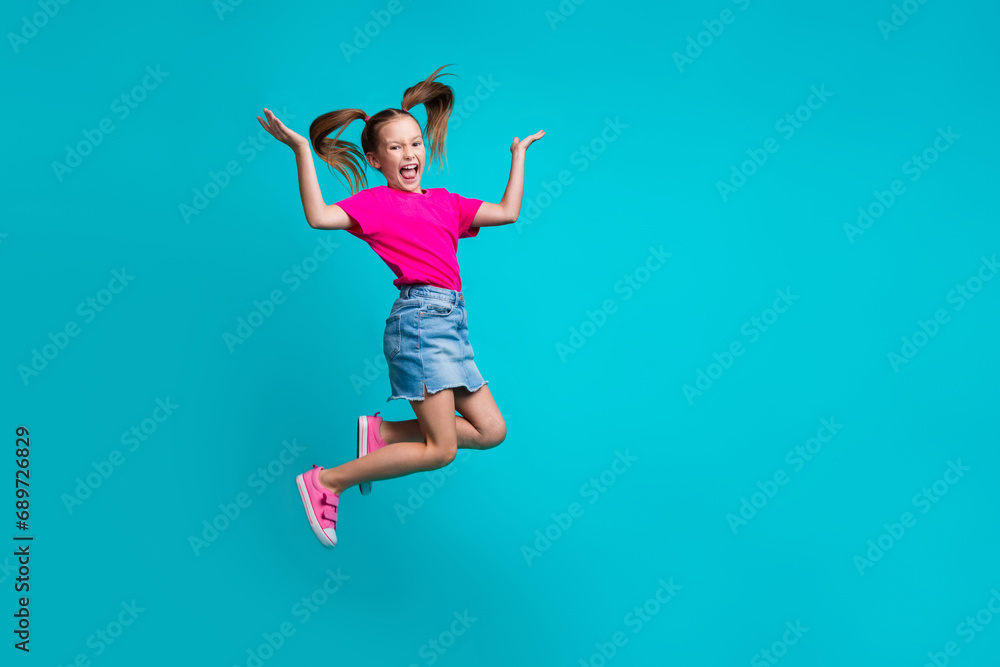 Full size photo of optimistic girl dressed pink t-shirt skirt palms demonstrate offer empty space isolated on turquoise color background