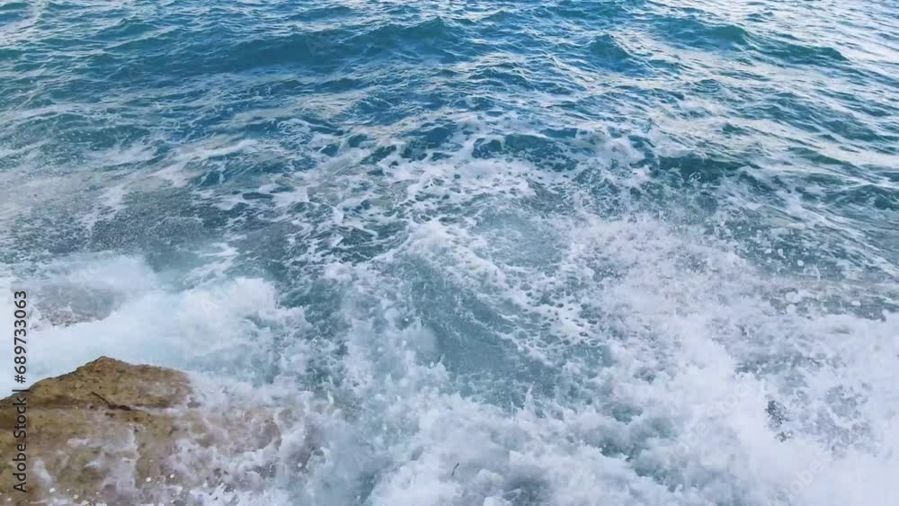 Sea waves swirling and crashing and covering rocks. Nature background. Sea waves swirling and crashing and covering rocks. Nature background.