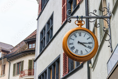 Close-up of big clock on the building in Switzerland