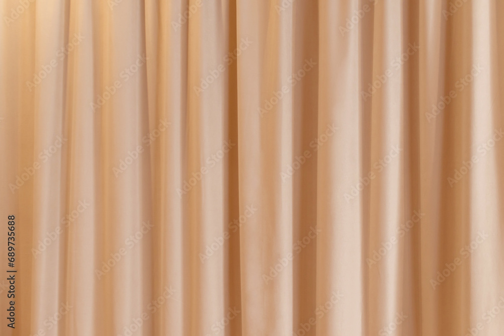 Obraz premium Peach fuzz color curtain that dropped down as a straight line. Background for inserting text, empty spaces.