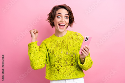 Photo of lady influencer fashion blogger celebrate victory online auction bought clothes using cellphone isolated on pink color background photo