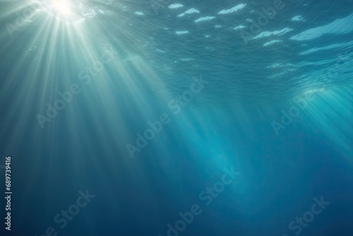 Underwater ocean - blue abyss with sunlight - diving and snorkeling. Mesmerizing sun rays beneath the ocean surface