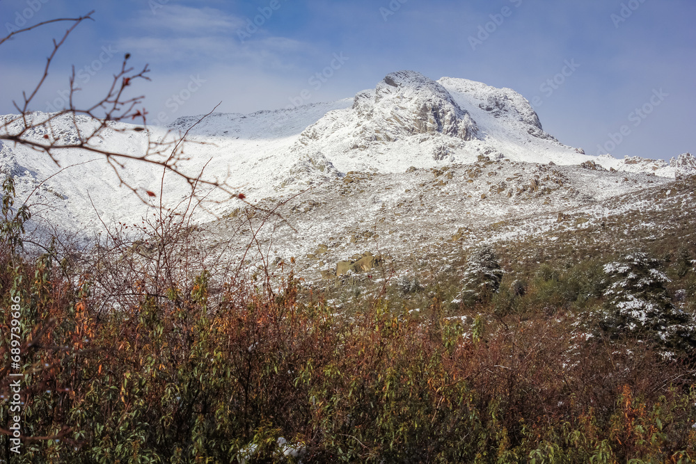 snowfall on the mountain, snowy mountain top with cold blue sky