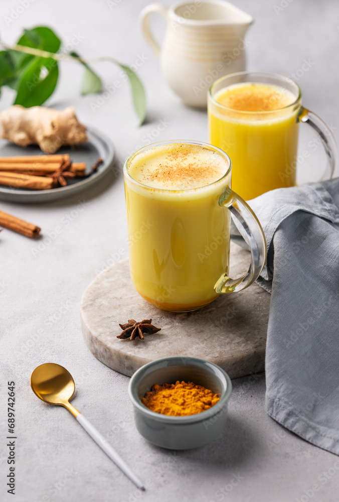 Turmeric golden milk latte with spices and honey. Detox, immunity boosting, anti-inflammatory, healthy, cozy drink - obrazy, fototapety, plakaty 