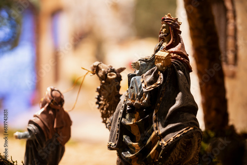 Figurine of the wise man Melchior on a camel nativity scene figures, in a nativity scene, in Borja, Zaragoza, Spain photo