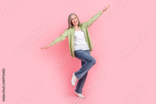 Photo of optimistic cheerful woman wear trendy clothes have fun fly air rejoice holiday vacation isolated on pink color background