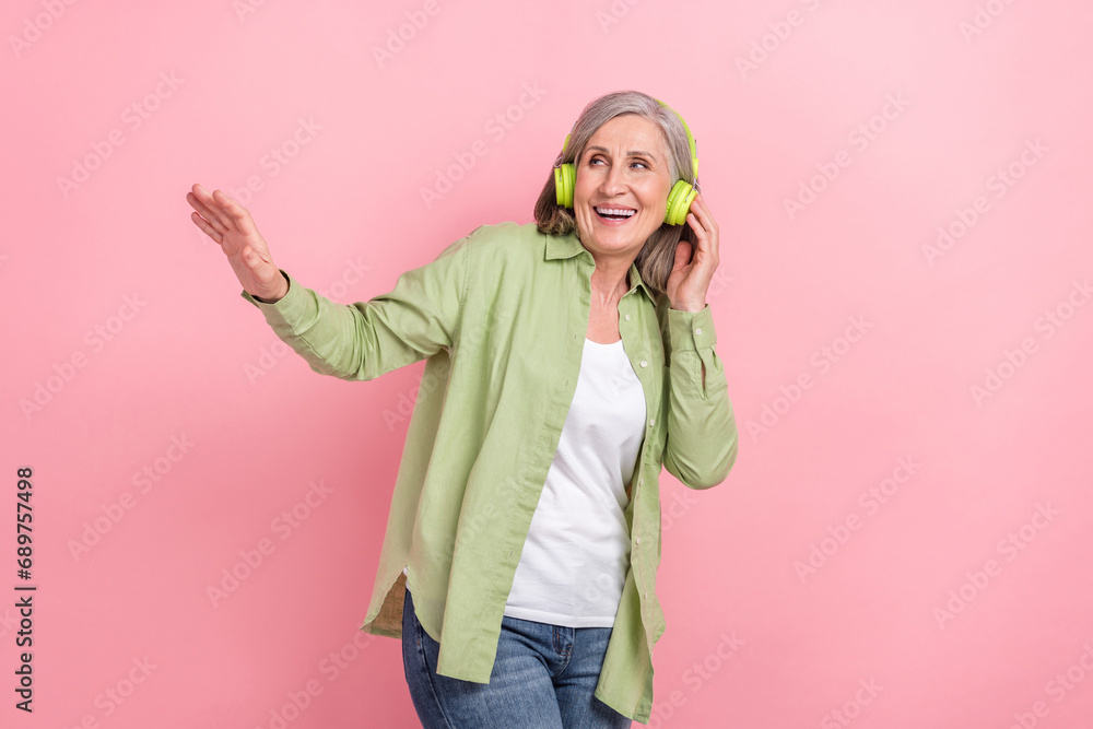 Photo of charming lovely retired good mood lady wear green trendy clothes look up empty space nice offer isolated on pink color background Photo of charming lovely retired good mood lady wear green trendy clothes look up empty space nice offer isolated on pink color background