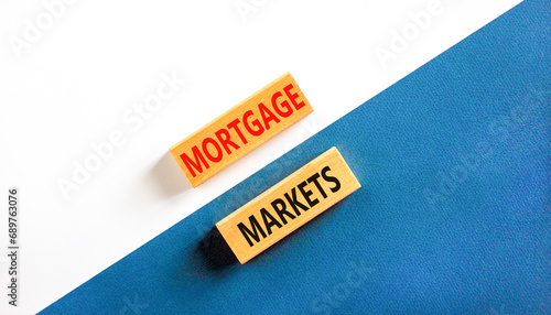 Mortgage markets symbol. Concept words Mortgage markets on beautiful wooden blocks. Beautiful white and blue background. Business mortgage markets concept. Copy space.