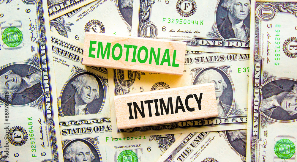 Emotional intimacy symbol. Concept words Emotional intimacy on beautiful wooden blocks. Dollar bills. Beautiful background from dollar bills. Psychology emotional intimacy concept. Copy space.