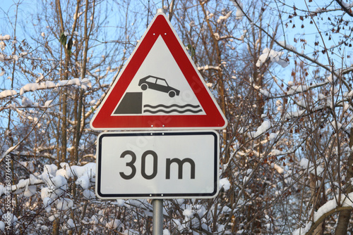 traffic signs on the way, Be careful, danger of getting the vehicle into the water, river bank