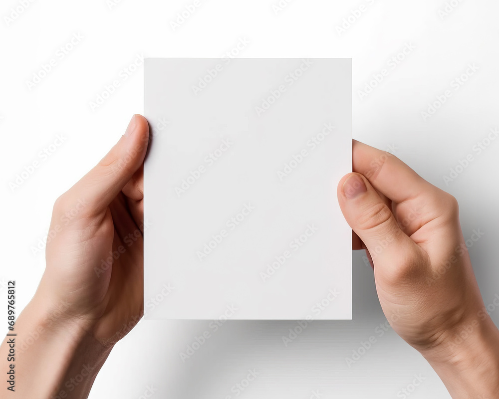 Close up of hands holding a blank business card isolated on white background Close up of hands holding a blank business card isolated on white background