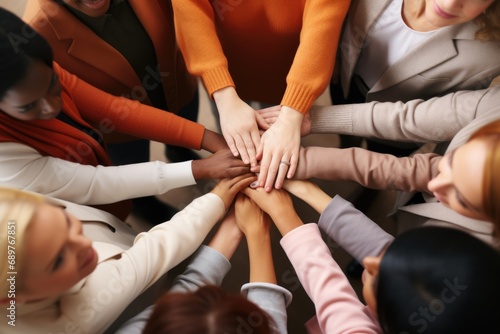 A group of people joining their hands together in unity. Suitable for team building  collaboration  and partnership concepts