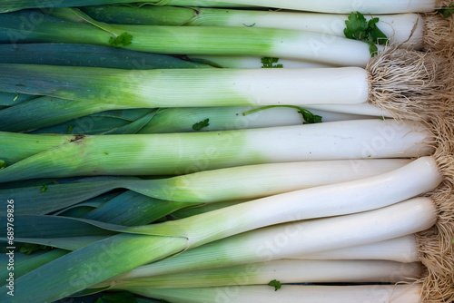leek as a background, fresh vegetables from a market in detail
