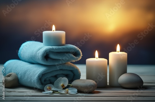 Spa and wellness setting with stones, candles and towel. Blue dayspa nature set with copyspace photo