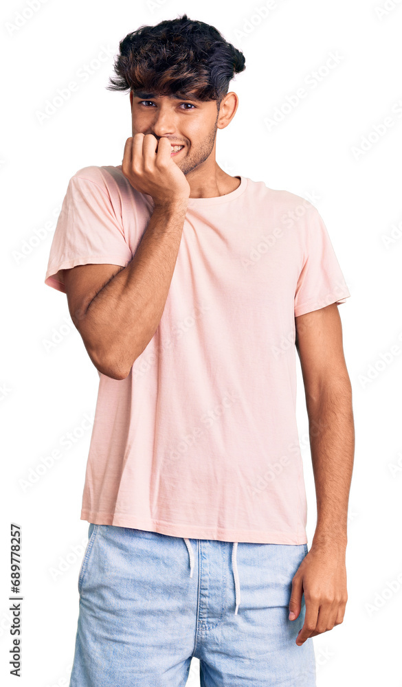 Young hispanic man wearing casual clothes looking stressed and nervous with hands on mouth biting nails. anxiety problem. Young hispanic man wearing casual clothes looking stressed and nervous with hands on mouth biting nails. anxiety problem.