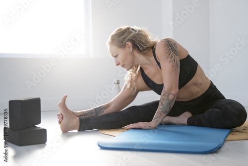 nice woman practicing yoga in job studio