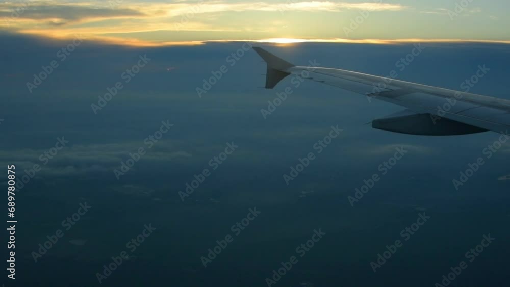 Video recorded from the window of an airplane, showing a trip, you can see the clouds, the sky, the plane's wing and the sunset. Video recorded from the window of an airplane, showing a trip, you can see the clouds, the sky, the plane's wing and the sunset.