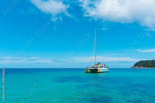 Sailing yacht in the sea. Sailboat in the sea under sunlight, luxury summer adventure, outdoor activities at sea. Sailboat sailing on ocean..