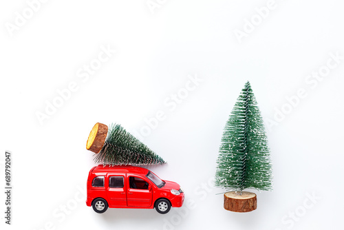 Red toy car with Christmas tree on the roof. Festive New Year concept