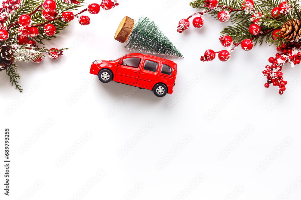 Festive New Year decoration and red toy car with Christmas tree on the roof
